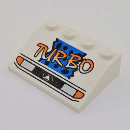 Brick Sloped 33° 3 × 4 with Headlights, Yellow 'TURBO', Blue Background and Black Spots Print